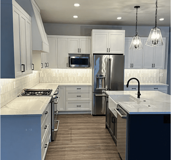 Modern kitchen with white cabinets and a large island.
