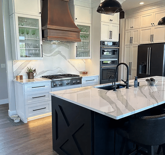 Modern kitchen with marble island and black accents.